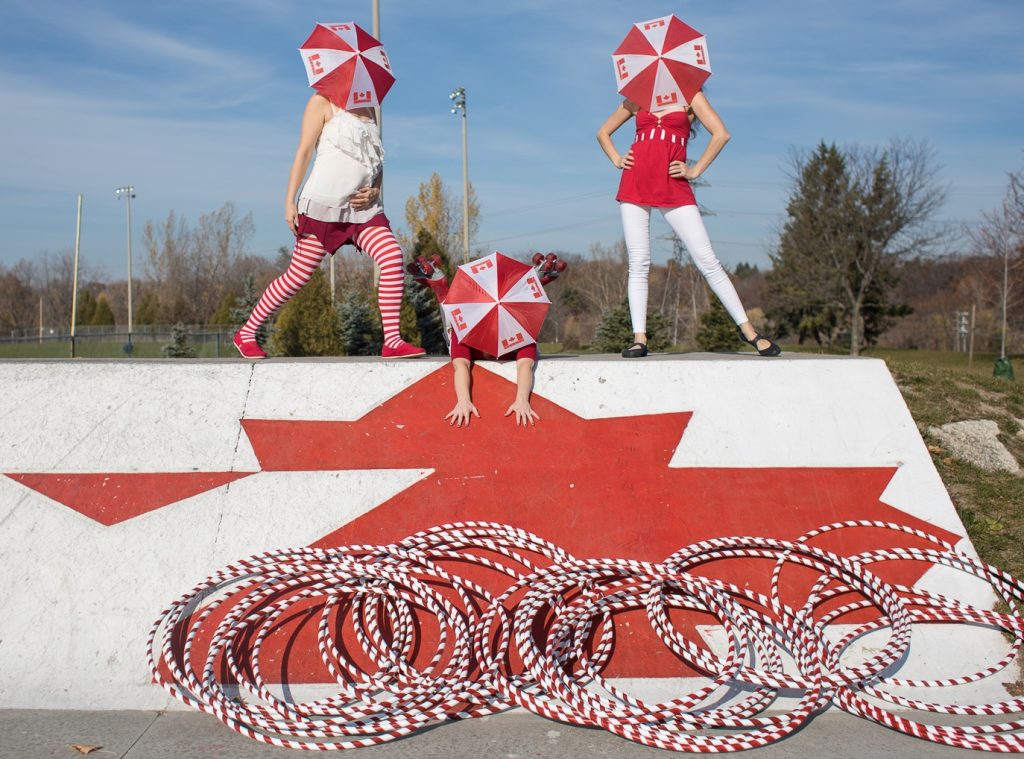 Canada 150 performers with hula hoops and umbrella faces