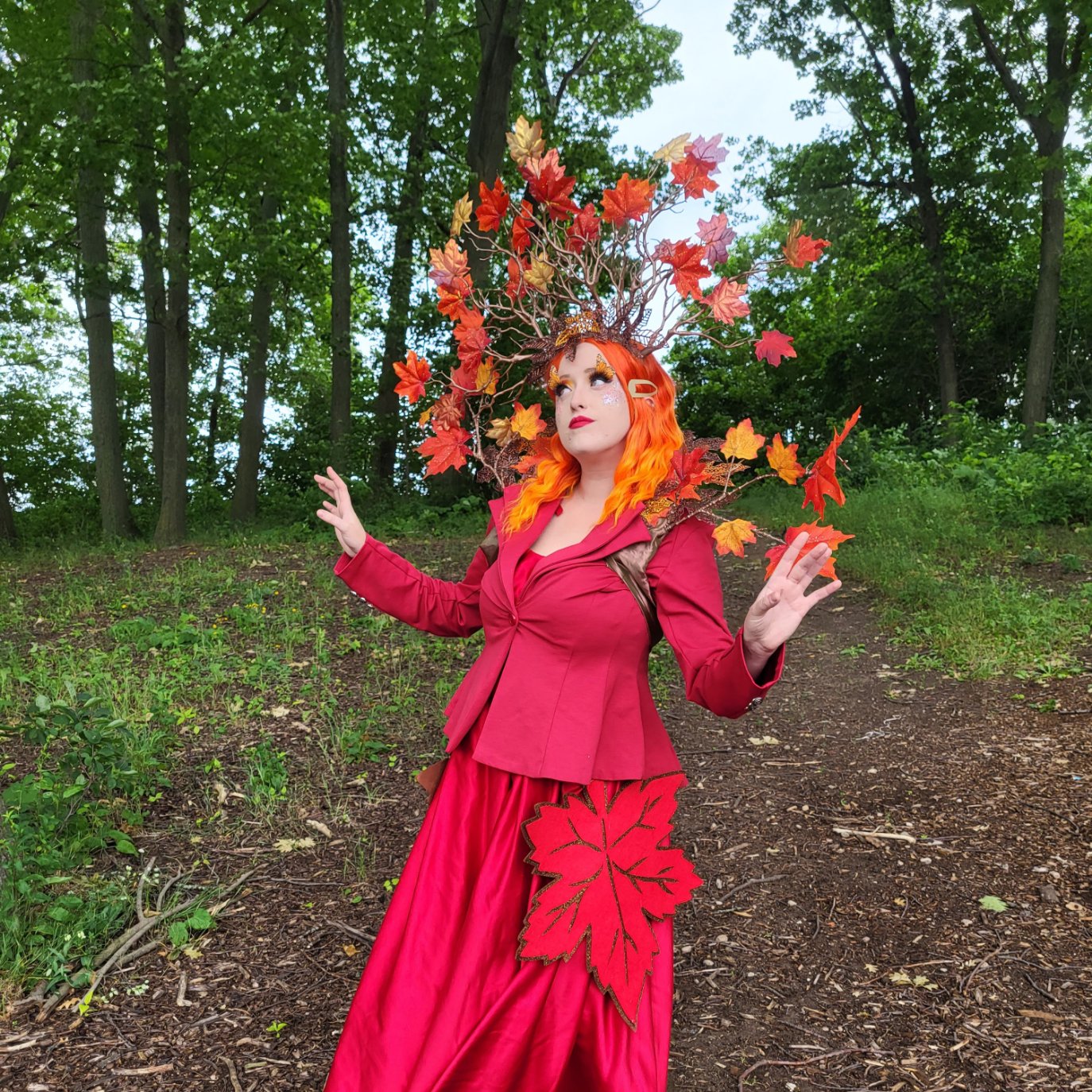 maple leaf character dressed all in red with maple leaves sprouting out of her head