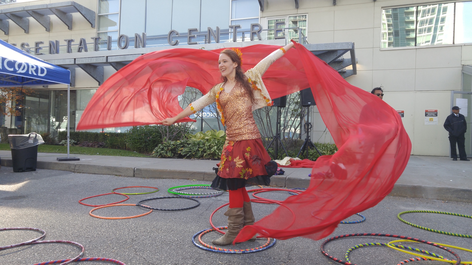 fall fairy red silk banners and hula hoops all around her feet