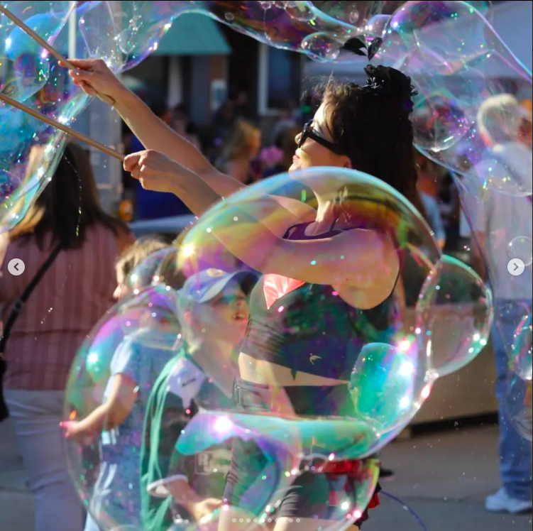 Zoe Stardust makes a swath of bubbles big and small around her